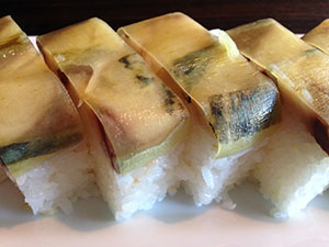 Several pieces of oshizushi showing the square form and pressed saba.