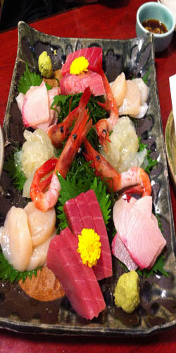 A plate vith various types of sashimi.
