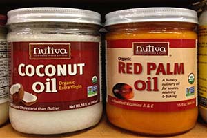 Jars of palm and coconut oil showing the red and white colors respectively.